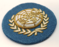 UN Nations Round White and Gold on Light Blue Wire Braided Beret Badge