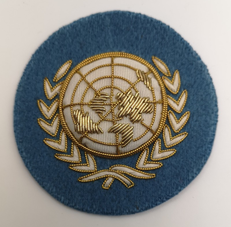 UN Nations Round White and Gold on Light Blue Wire Braided Beret Badge