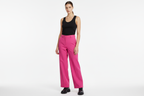 Female model pink trousers - black vest