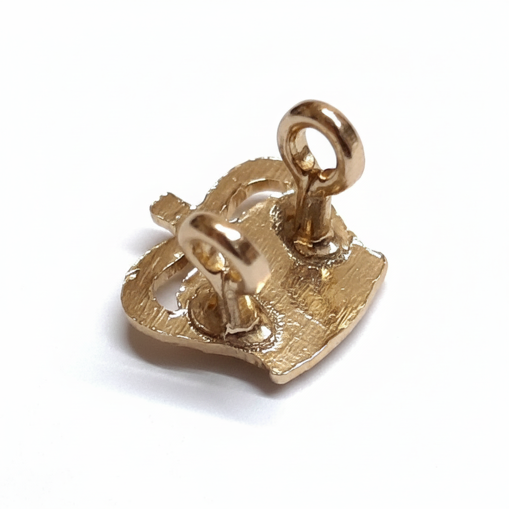 Gold crown badge back view showing pin and loop fitting on white background