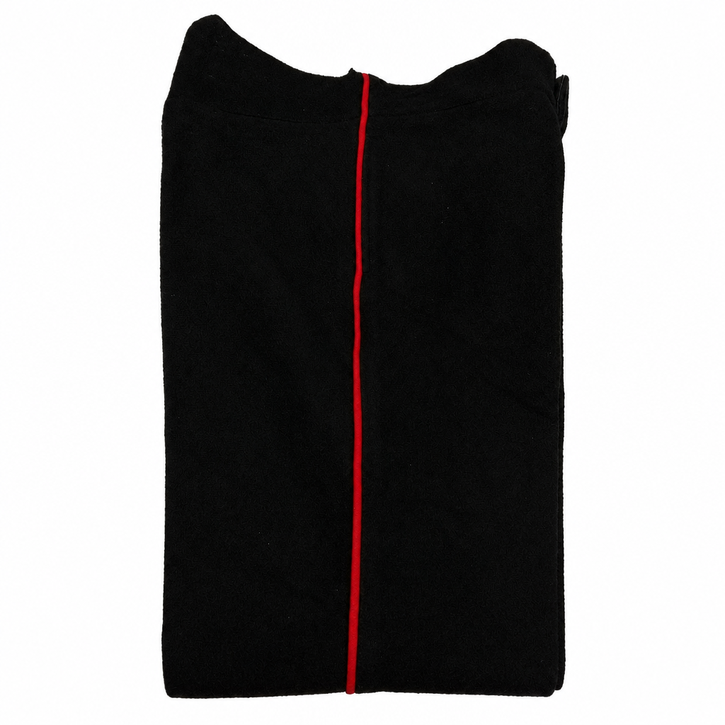Black wool dress trousers with red piping on a white background