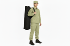Model with lighter olive-sand clothing and unchanged black kit bag