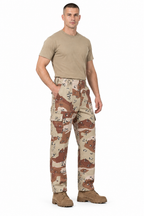 Soldier wearing desert camouflage trousers, a tan T-shirt and brown desert boots on a white background